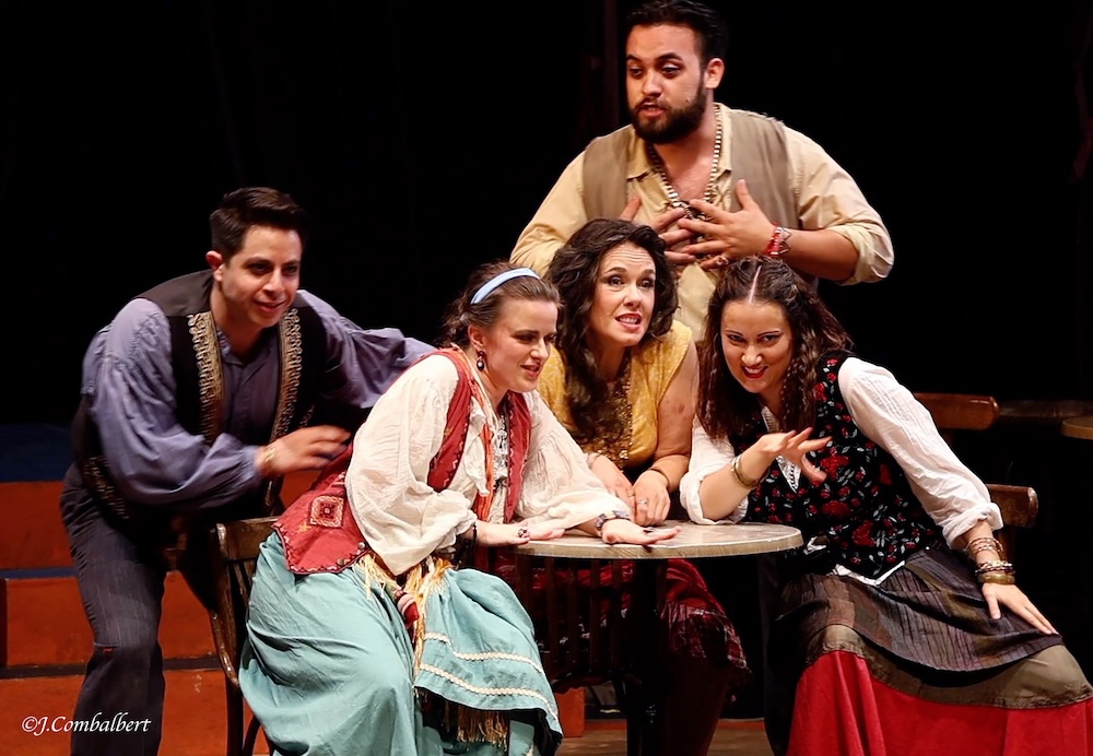 Five singers on stage performing the opera Carmen